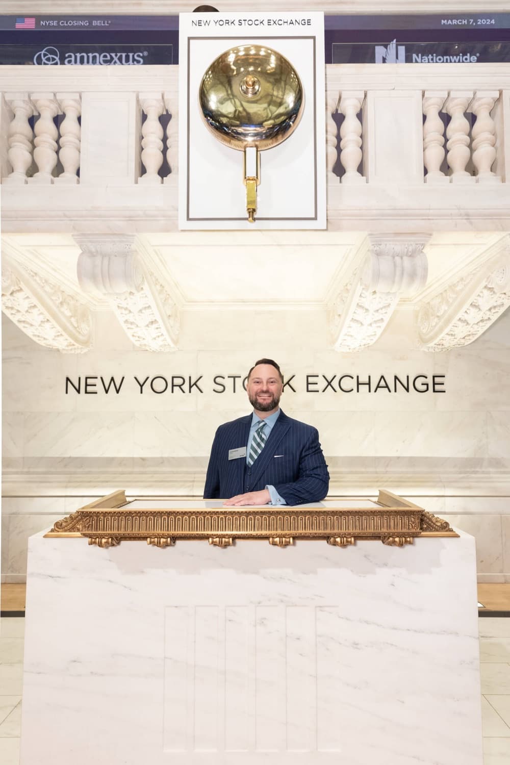 Jason Berube on the podium at the New York Stock Exchange